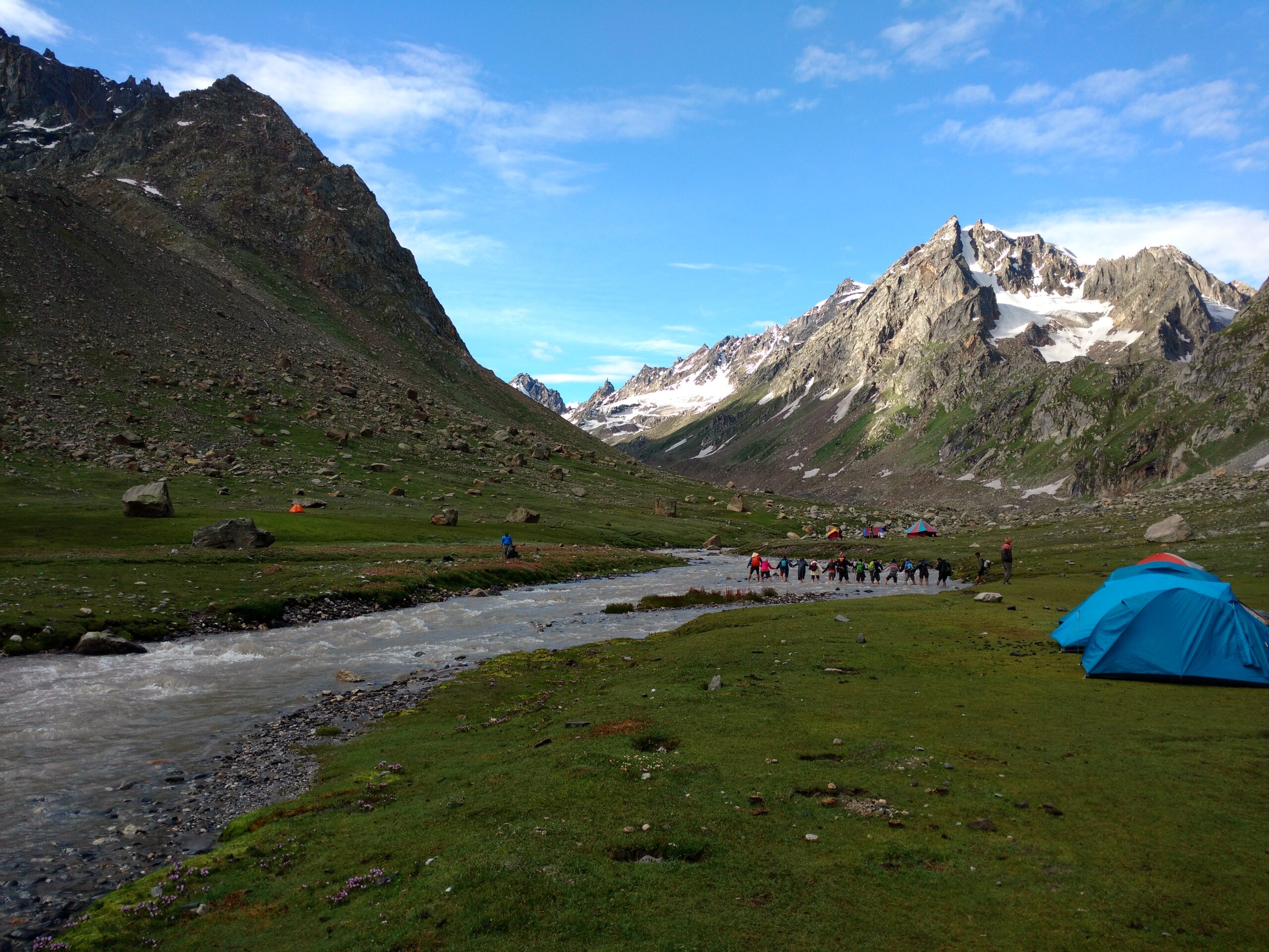 Himachal trekking River crossing Holding hands for river crossing